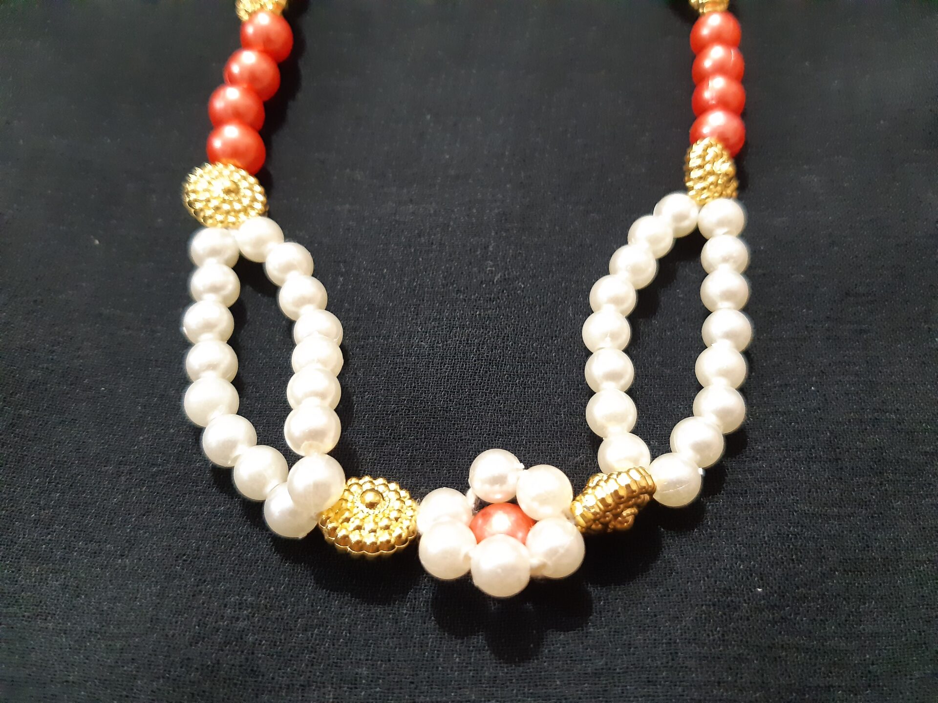 Handmade jewellery made of white and rose gold plastic beads in unique design. Suitable for all Gods and Goddesses. Glossy beads. The tie length can be adjusted as per individual. Can be used as gift to commemorate festivals/Pooja. Decoration for Hindu idols.