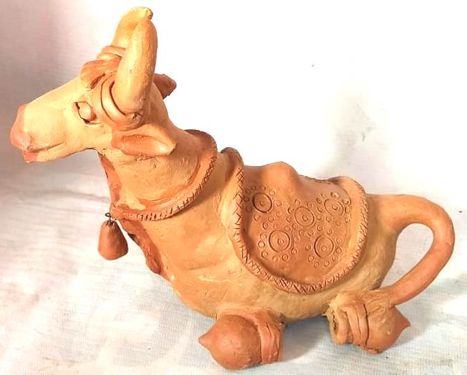 Sitting cow of Clay made by local female artisan.